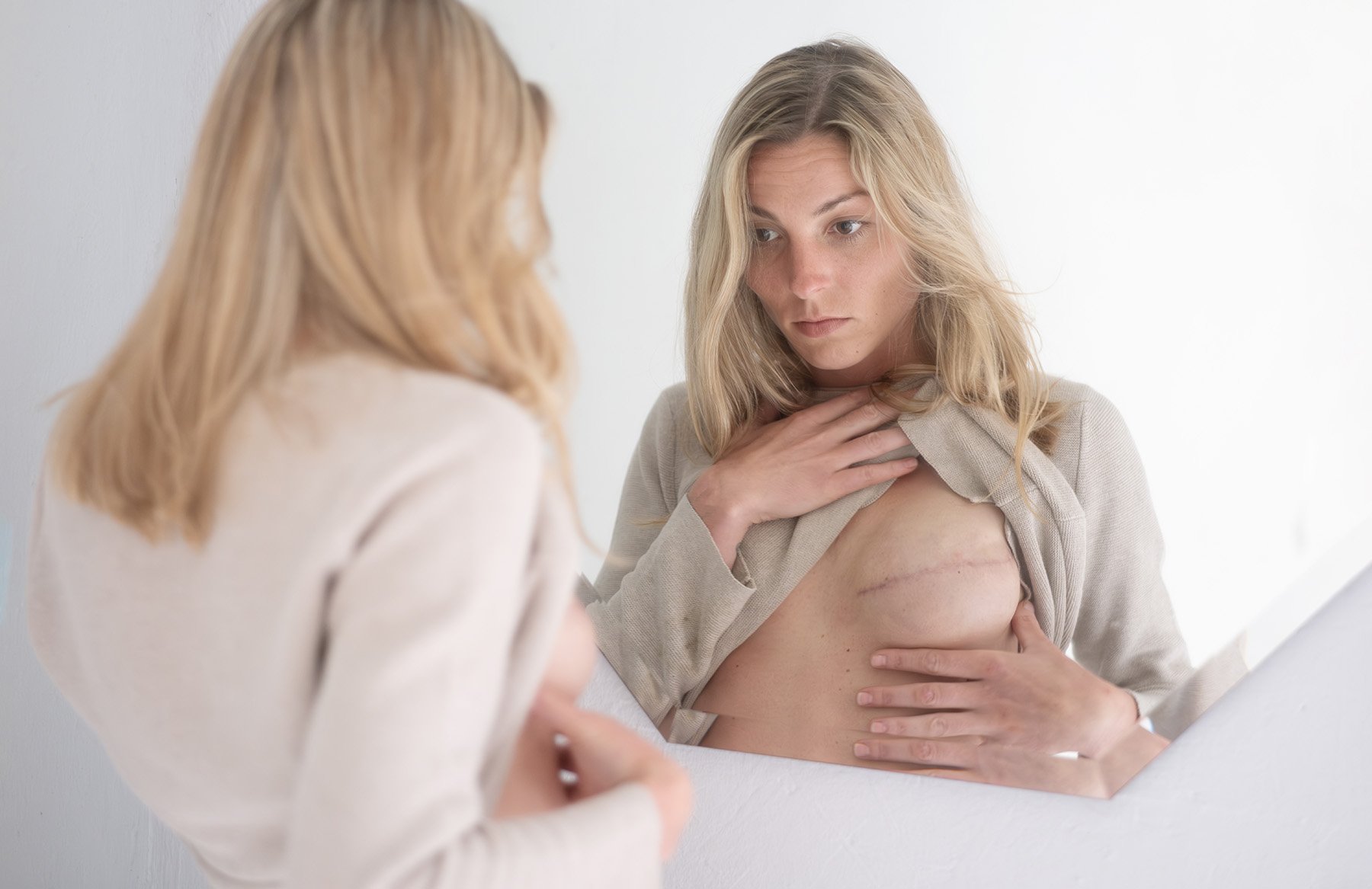 woman-examining-breast-reconstruction